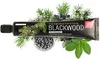 A tube of SPLAT Blackwood toothpaste is shown with juniper branches and berries, and a small bowl of charcoal pieces. Produktbild-Vorschau