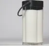 A close-up shot of a milk container with a black lid and a gray handle, filled with white liquid. Anteprima dell’immagine prodotto