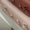 A close-up view of two decorative storage boxes stacked on top of each other. Podgląd zdjęcia produktu