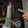 A close-up shot of a person's finger interacting with the digital display of a Kenwood kitchen appliance. Produktbild-Vorschau