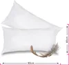 Two white pillows are shown, one on top of the other, with a feather in front of the bottom pillow. Náhľad obrázku produktu