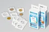 A collection of coin holders and two boxes of coin holders are arranged on a light gray surface. Produktbild-Vorschau