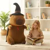 A young girl is reading a book next to a large plush toy in a room with bookshelves. Náhľad obrázku produktu