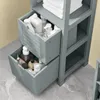 A close-up view of a gray wooden bathroom cabinet with two open drawers filled with various toiletries and cleaning products. Anteprima dell’immagine prodotto