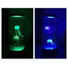 Two images of a jellyfish lamp, one lit with green light and the other with blue light, showing the jellyfish inside. Anteprima dell’immagine prodotto