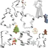 A collection of Christmas-themed cookie cutters and some decorated cookies. Podgląd zdjęcia produktu