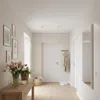 A hallway with a console table, artwork, and flowers. Náhľad obrázku produktu