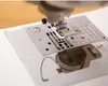 A close-up view of the needle plate and presser foot of a sewing machine. Produktbild-Vorschau