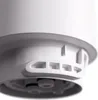 A close-up, angled view of the bottom of a white water filter cartridge, showing its connection mechanism and ventilation slots. Produktbild-Vorschau