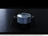 A pot with a lid sits on a black induction cooktop. Produktbild-Vorschau