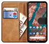 A book-style phone case with a smartphone inside, showing the screen and some cash and cards in the case slots. Podgląd zdjęcia produktu