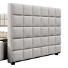 A close-up, side view of a beige upholstered bed frame with a tufted headboard. Náhľad obrázku produktu