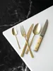 A set of cutlery arranged on a white surface with a black marble background. Produktbild-Vorschau