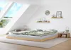 A bedroom with a low bed, skylights, and decorative items on the wall. Produktbild-Vorschau
