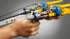 A hand holding a LEGO Star Wars Anakin's Podracer model. Produktbild-Vorschau