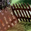 A brown garden fence in a grassy outdoor setting. Náhľad obrázku produktu