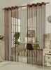 A dining area with chairs and a table, partially obscured by string curtains. Produktbild-Vorschau