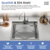 A stainless steel kitchen sink with a faucet and soap dispenser, set on a countertop with decorative items. Produktbild-Vorschau