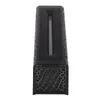 A close-up, top-down view of a black diffuser with a textured, cracked pattern and a gray stick-like object inside. Náhled obrázku produktu