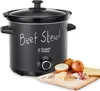 A black Russell Hobbs slow cooker with "Beef Stew!" written on it in chalk, next to some ingredients on a wooden board. Anteprima dell’immagine prodotto
