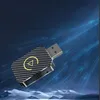 A USB car adapter with a carbon fiber pattern and a yellow play button logo, set against a futuristic blue background with light streaks. Produktbild-Vorschau