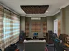 A room set up as a home theater or listening room, with acoustic treatment panels on the walls and ceiling, and multiple speakers. Náhľad obrázku produktu