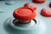 A close-up shot of a video game controller's joystick and buttons. Produktbild-Vorschau