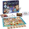 A board game and its components are laid out on a white surface, with the game box in the background. Produktbild-Vorschau