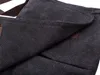 A close-up view of the dark fabric of a bag, showing stitching and a brown accent. Podgląd zdjęcia produktu