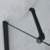 A close-up view of a black metal bracket and glass panel, likely part of a shower enclosure, against a textured gray wall. Produktbild-Vorschau