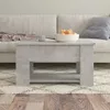 A concrete gray coffee table is placed in front of a sofa in a living room. Náhled obrázku produktu