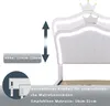 Close-up of a white bed frame with decorative crowns and LED lighting, showing measurement indicators and text about adjustable headboard and mattress size. Náhled obrázku produktu