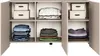 A beige sideboard with its doors open, revealing shelves filled with folded clothes and storage boxes. Voir les images du produit