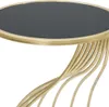 A close-up view of a round table with a black top and a gold base. Anteprima dell’immagine prodotto