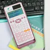 A pink scientific calculator is placed on a keyboard and books. Podgląd zdjęcia produktu