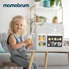 A young girl is playing with a wooden coffee and ice cream bar toy. Anteprima dell’immagine prodotto