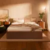 A bedroom scene with a bed, nightstands, and a floor lamp. Produktbild-Vorschau