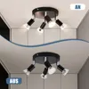 Two images of a black ceiling spotlight with multiple adjustable heads, one labeled 'AN' and the other 'AUS'. Produktbild-Vorschau