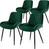 Four dark green velvet dining chairs with diamond tufting and black metal legs are arranged on a white background.