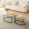 A living room scene with a sofa and two nesting coffee tables. Produktbild-Vorschau