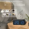 A digital alarm clock is shown on a bedside table, with a graphic overlay detailing its wake-up sound options. Produktbild-Vorschau