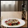 Sitia Premium Gold 0,2 % Olivenöl Glasflasche mit zubereitetem Fischfilet Produktbild-Vorschau