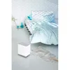 A bedroom scene with a bed, a white humidifier, and decorative vases. Podgląd zdjęcia produktu