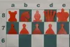 A chess set with pieces arranged on a chessboard. Voir les images du produit