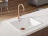 A modern kitchen sink with a copper faucet. Produktbild-Vorschau