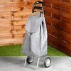 A shopping trolley with a grey bag stands on a concrete surface in front of a wooden fence and artificial grass. Anteprima dell’immagine prodotto
