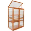 A wooden greenhouse with clear panels and shelves, shown against a white background. Produktbild-Vorschau