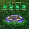 A solar-powered garden light is shown in the grass during a rain shower, with icons indicating its water resistance and suitability for different weather conditions. Produktbild-Vorschau
