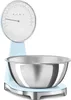 A light blue Smeg kitchen scale with a silver bowl is shown against a white background. Náhled obrázku produktu