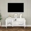 A white media console with a television mounted above it in a room with paneled walls and a wooden floor. Náhľad obrázku produktu